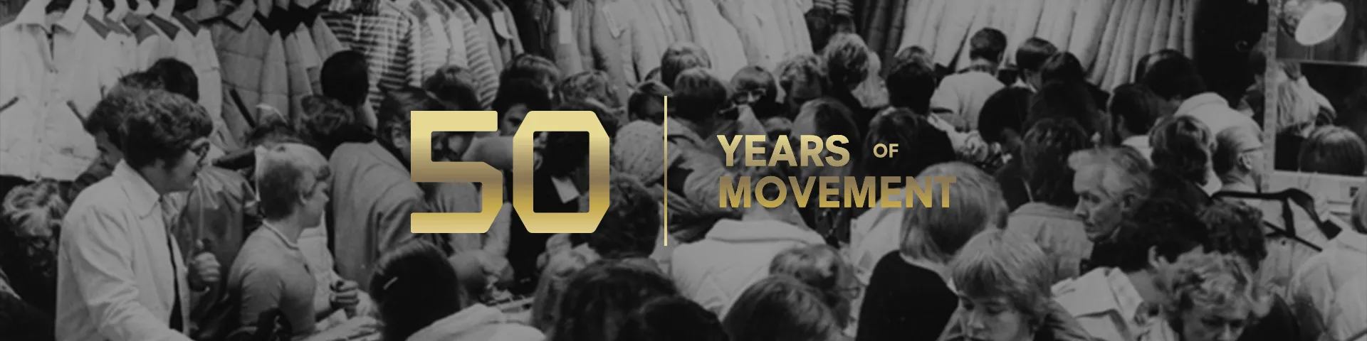 Black and white crowd scene with a "50 Years of Movement" slogan in bold gold text superimposed over the image.