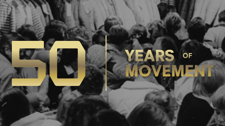 Black and white crowd scene with a "50 Years of Movement" slogan in bold gold text superimposed over the image.
